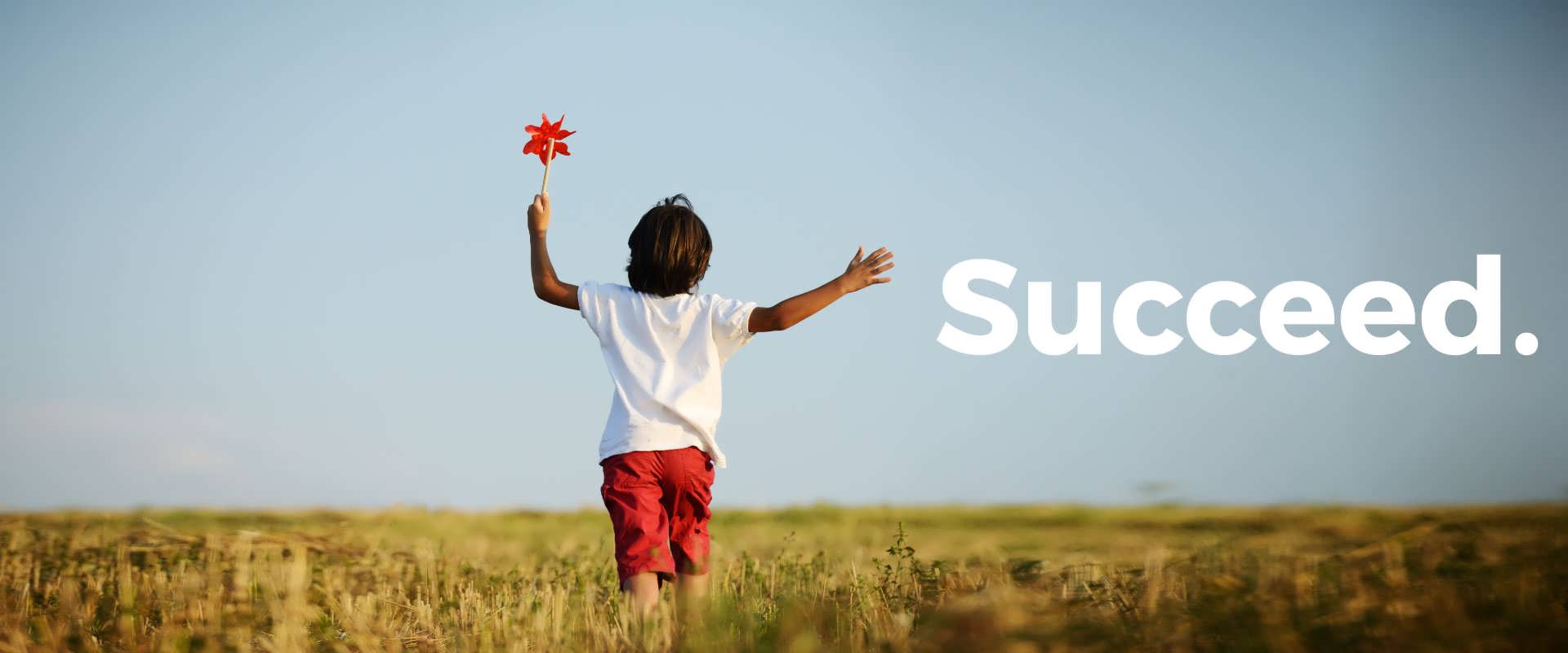 Child rejoicing in field - Succeed.